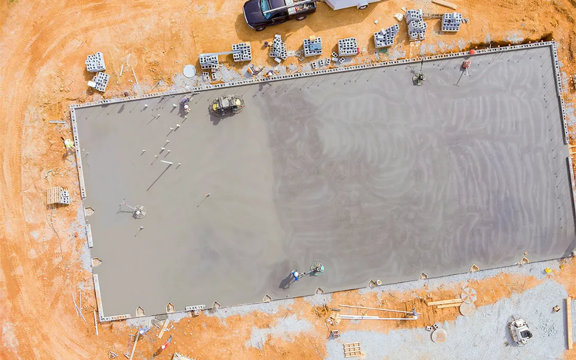 concrete-is-poured-into-wet-foundation-a-mason-finishes-polished-concrete-using-concrete-polishing